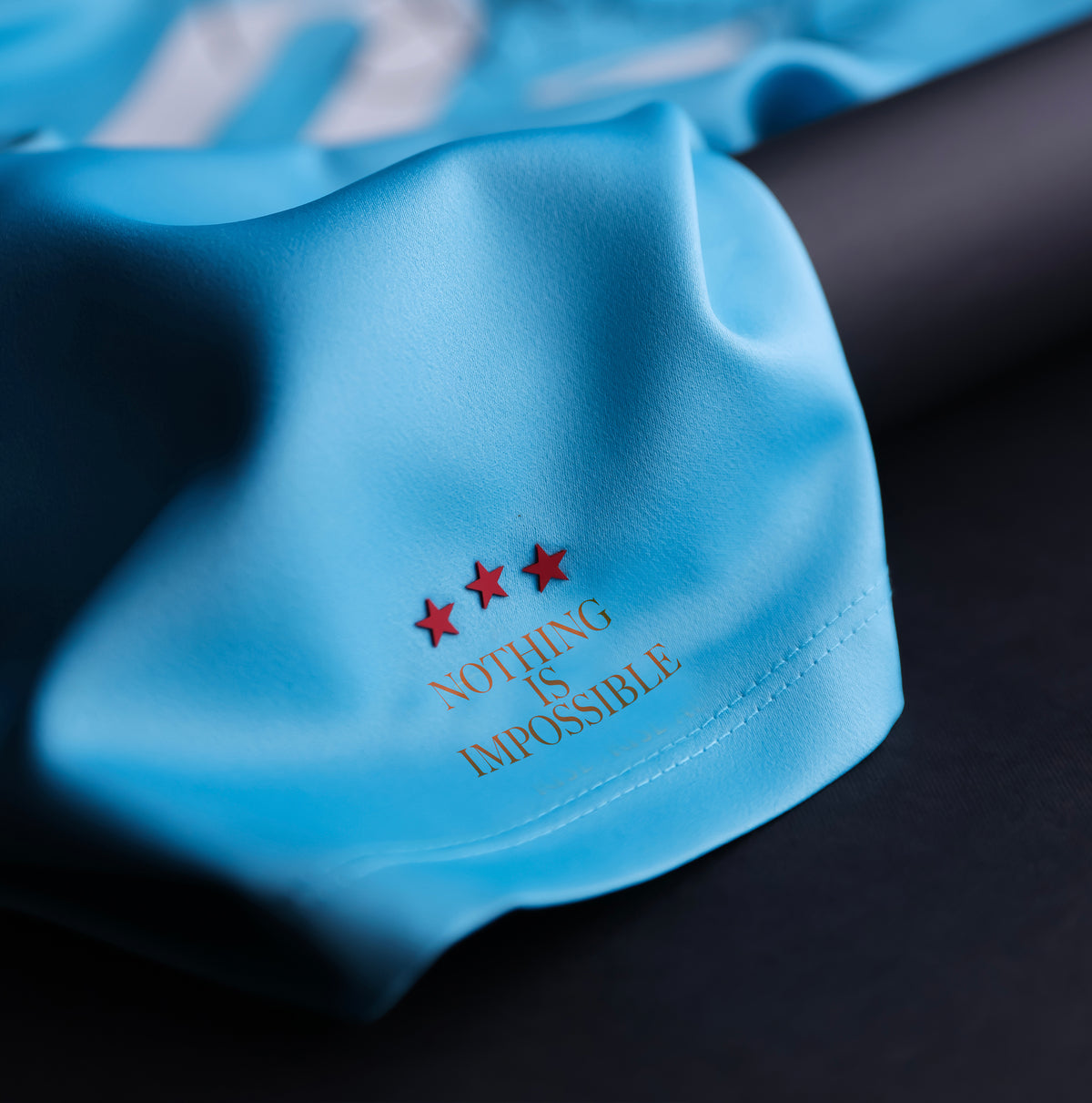 Close-up of the GOAT SKINS Michael Jackson limited edition collectible jersey showing the three-star Nothing Is Impossible detail
