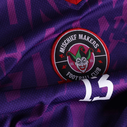 Close-up of the GOAT SKINS Joker limited edition collectible jersey showing the embroidered Mischief Makers crest and number 13